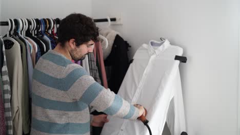 Young-man-ironing-his-shirt-at-home