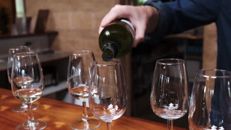 Pouring-White-Wine-in-Glasses-at-the-bar-counter