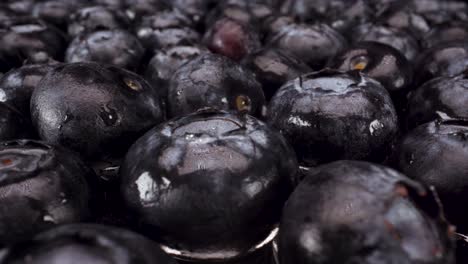 macro-view-passing-over-turning-blueberries-on-glass,-4k-shot-of-healthy-fresh-fruit,-nutritional-diet,-blueberry-acai