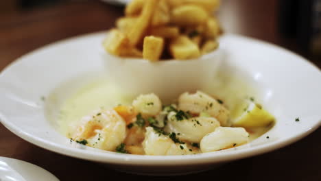 Tasty-gourmet-dish-of-Shrimp-in-cream-sauce-and-French-fries