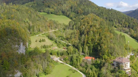 A-drone-shot-of-mountain-road-valleys-forest-trees-hills-at-Eisenkappel-Vellach,-Austria