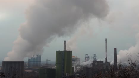 Cooling-towers-of-a-factory-releasing-white-smoke-to-atmosphere