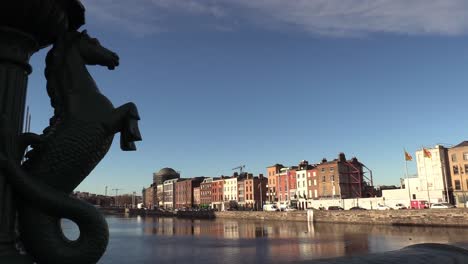 Still-shot-of-Dublin-City-life-in-December-2020-with-a-sea-horse-on-a-bridge-with-four-courts-in-the-background
