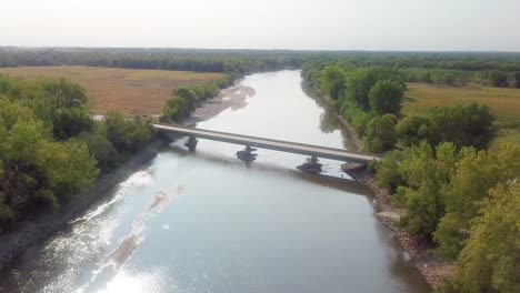 Drone-aerial-view-of-F62-highway-bridge-over-the-Iowa-River-at-Hills-Iowa
