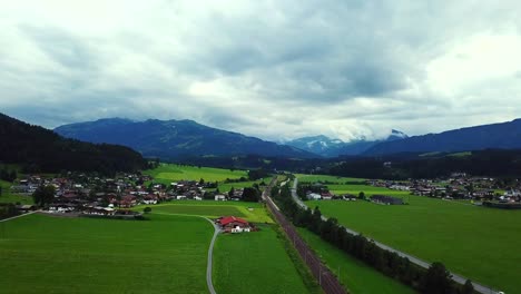 Aerial-view-above-Oberndorf,-Austria,-and-a-stormy-cloudscape
