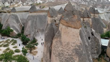 Cappadocia-Turkish-goreme-volcanic-rock-formation-ancient-conical-town-aerial-pull-back-view
