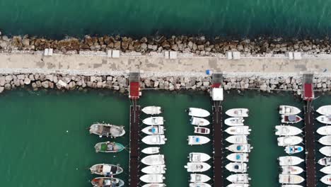 Slide-Right-Drone-shot-with-the-green-sea-Porto-di-Scauri-Marina-di-Minturno-full-HD-50
