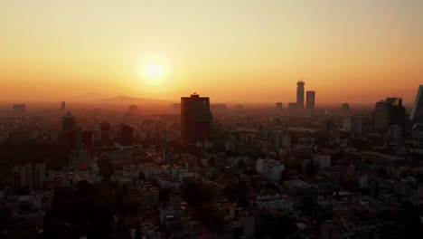 Misty-sunrise-scene-in-Mexico-City,-slow-aerial-drone-lateral-fly