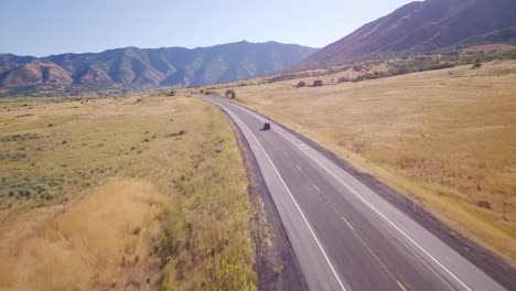 Drone-chases-a-side-by-side-on-a-lonely-desert-road-up-into-the-valley