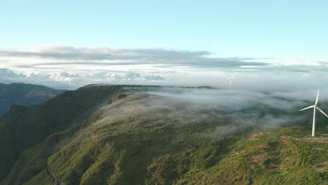 Windmills-generating-wind-energy-on-top-of-mountain-in-Madeira,-aerial
