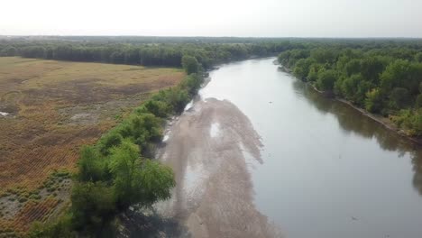 Drone-aerial-view-of-following-the-Iowa-River-water-trail-and-large-sandbar-in-the-river