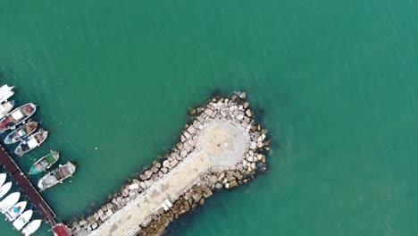 Spin-Drone-shot-with-the-green-sea-Porto-di-Scauri-Marina-di-Minturno-full-HD-50-fps