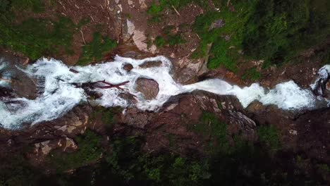Aerial-view-of-water-flowing-down-a-rocky-mountain,-Walcherfall-waterfall,-Ferleiten,-Austria