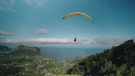 Paraglider-takes-off-from-high-mountain-on-Madeira-island,-aerial