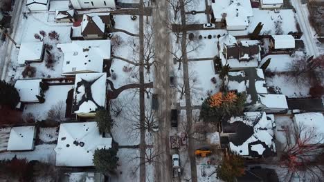 4-4-Aerial-fly-over-winter-luxury-residential-housing-area-twilight-where-the-sunsets-and-its-rays-on-the-bare-icy-tree-tips-and-a-home-with-construction-workers-rebuildinga-an-entrance-in-the-cold