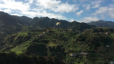 Recreational-paraglider-above-picturesque-mountains-in-Madeira,-aerial