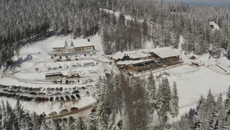 Kope-winter-sports-resort-in-the-Pohorje-mountains-with-heavy-snowfall,-Aerial-orbit-right-shot