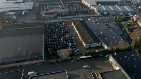 Wide-aerial-of-car-junkyard-on-industrial-site