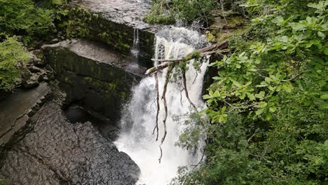 Slow-motion-cascading-Breacon-Beacons-idyllic-aerial-woodland-waterfalls-slow-push-in