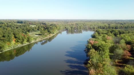 Low-angle,-slow-drone-view-following-the-Iowa-River-water-trail-on-a-sunny-late-summer-day-near-Iowa-City-Iowa