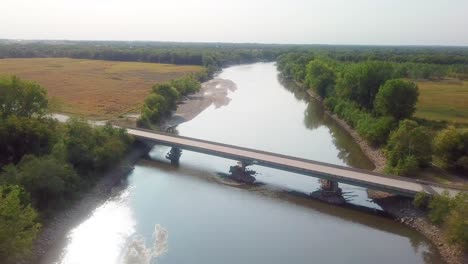 Drone-aerial-view-of-following-the-Iowa-River-and-water-trail-at-Hills-Iowa