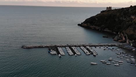 Pull-Back-Drone-shot-at-sunset-sea-view-at-port-of-Scauri-full-HD-50-fps