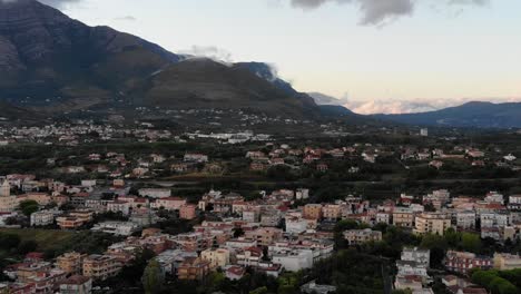 Drone-Shot-flies-over-the-City-of-Scauri-Italy-to-the-mountains-in-a-sunset-day-full-hd-50fps
