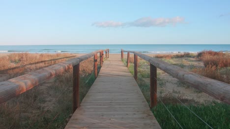 Wooden-boardwalk-leading-to-a-beautiful-beach