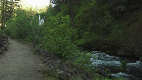 Stream-water-flowing-next-to-a-trail,-through-a-forest,-near-Burney-Falls,-California