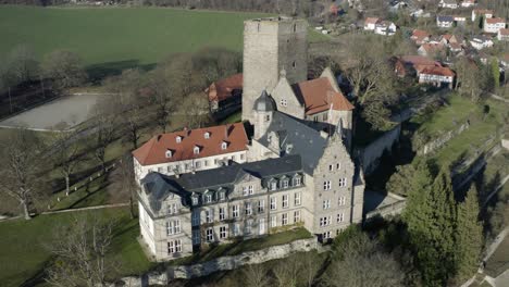 Drone-aerial-view-of-the-fairytale-castle-Adelebsen-on-a-beautiful-autmn-afternoon-in-golden-sunlight