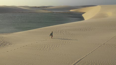 a-pretty-girl-walking-on-sand-dunes-during-sunset-in-Brazil