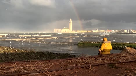 A-young-moroccan-woman-admiring-the-view-on-casablanca-with-the-rainbow