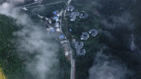 Small-Chinese-township-village-in-remote-mountain-landscape,-aerial-top-down