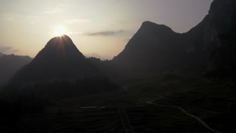 Beautiful-mountain-silhouettes-at-sunset,-karst-mountains-china,-aerial-view
