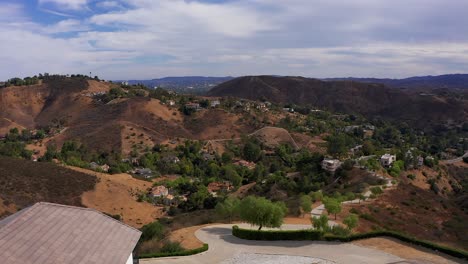 Aerial-flyover-roof-shot-revealing-Southern-CA-foothill-community