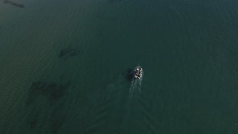 Aerial-view-of-fishing-boat-on-shallow-waters