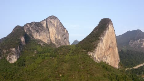 Chinese-karst-mountain-landscape-on-sunny-day,-aerial-reveal