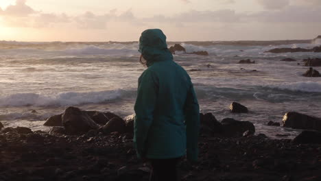 Free-woman-strolling-on-rocky-shores-of-Azores-Portugal