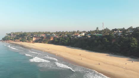 Varkala-Beach,-unique-palm-covered-red-cliffs