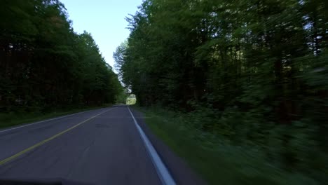 Car-driving-through-a-small-rural-road