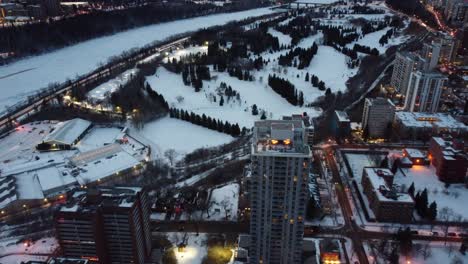 2-2aerial-birds-eye-view-flydown-night-time-over-winter-futuristic-modern-residential-rivers-edge-high-rises-by-golf-course-indoor-tennis-club-cross-country-skiing-snow-shoeing-posh-upscale-university