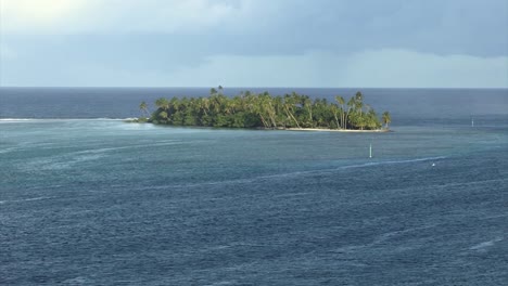 Aerial-view-of-a-Small-island-with-palm-trees-near-by-Raiatea-island,-French-Polynesia