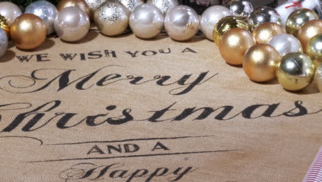 Xmas-Balls-and-We-wish-you-a-merry-Christmas-and-a-happy-new-year-written-on-fabric