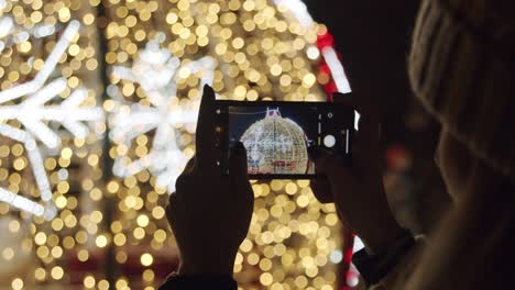 Person-Taking-Pictures-with-a-Phone-of-a-Christmas-Lights-at-Night