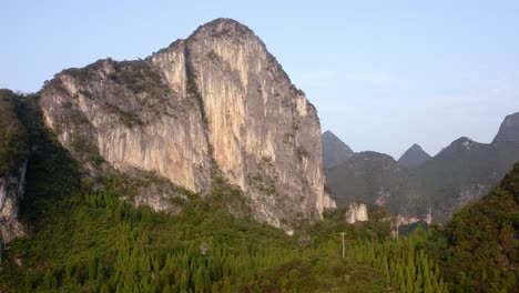 Beautiful-karst-mountain-rock-face-in-remote-Chinese-countryside,-aerial-view