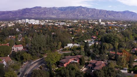 Low-aerial-panning-shot-of-Pasadena-with-mountains-in-the-background