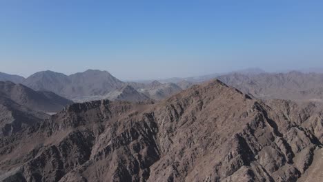 4k-Drone-footage:-Unveiling-shot-of-UAE-Mountain-range,-Khorfakkan-mountains,-Sharjah,-United-Arab-Emirates