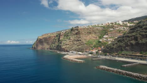 Calheta-town-on-top-of-cliffs-with-man-made-beach-on-shore-of-Madeira