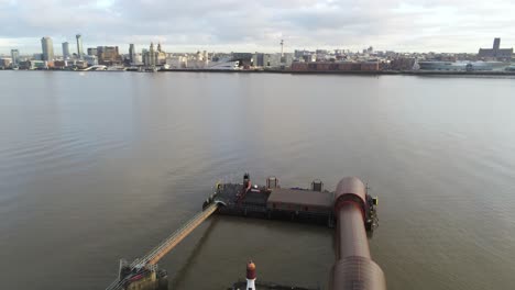 Woodside-ferry-village-terminal-aerial-left-dolly-across-Liverpool-harbour-skyline-pigeons-fly-through-shot