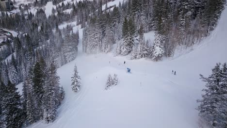 Skiers-and-Snowboarders-race-down-the-side-of-a-snow-packed-mountain-side-in-Utah
